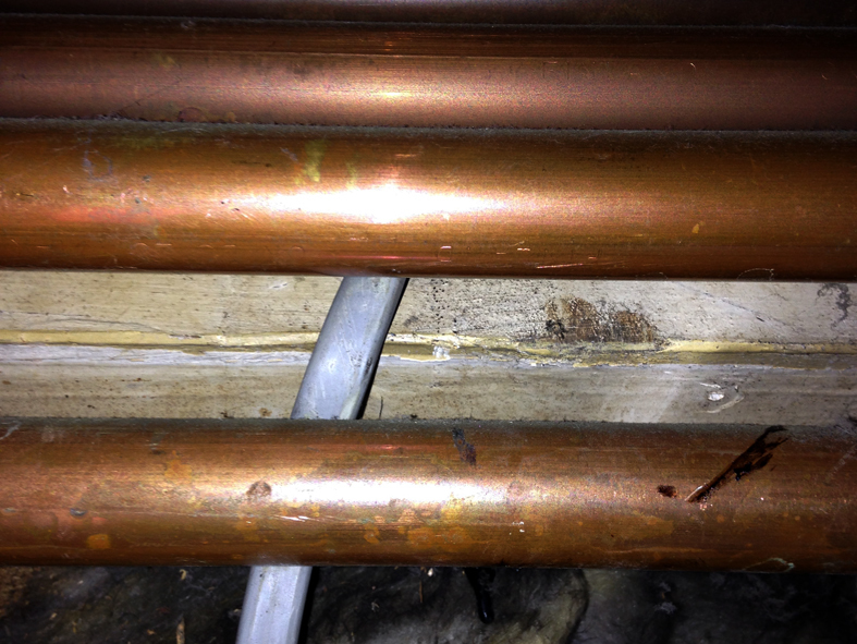 Cables trapped between heating pipework and the wall