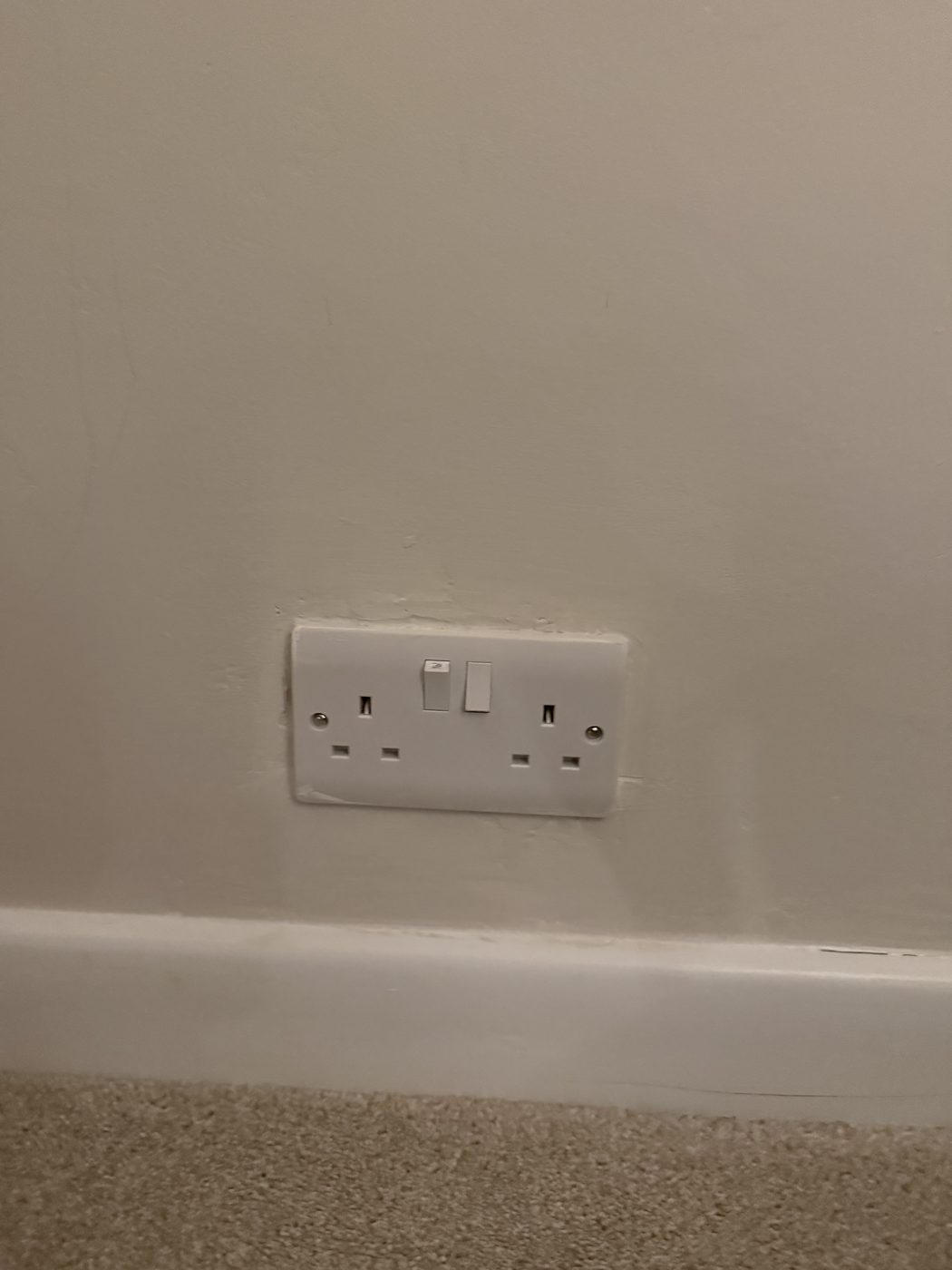 A new MK double socket fitted on a dark feature wall