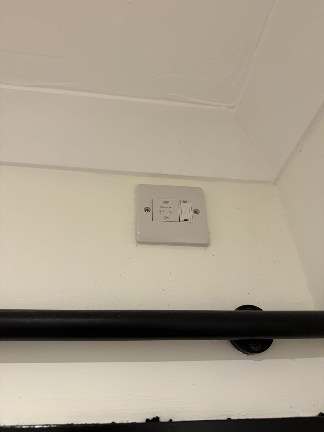 A socket moved up behind a TV bracket